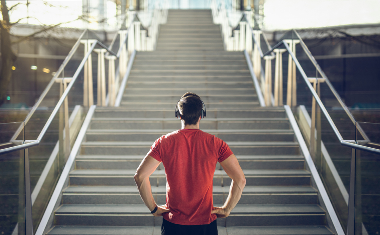 Person preparing to run op stairs, symbolizing the journey of building an exercise habit